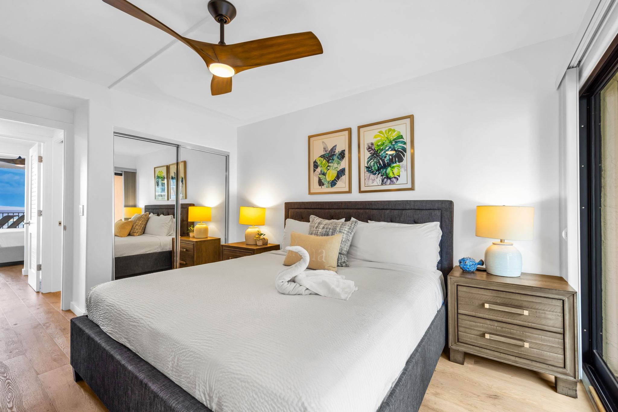 4401 Lower Honoapiilani Road, Unit B603 Lahaina, HI 96761 - Photo 23 of 41 a bedroom with a bed and a chandelier