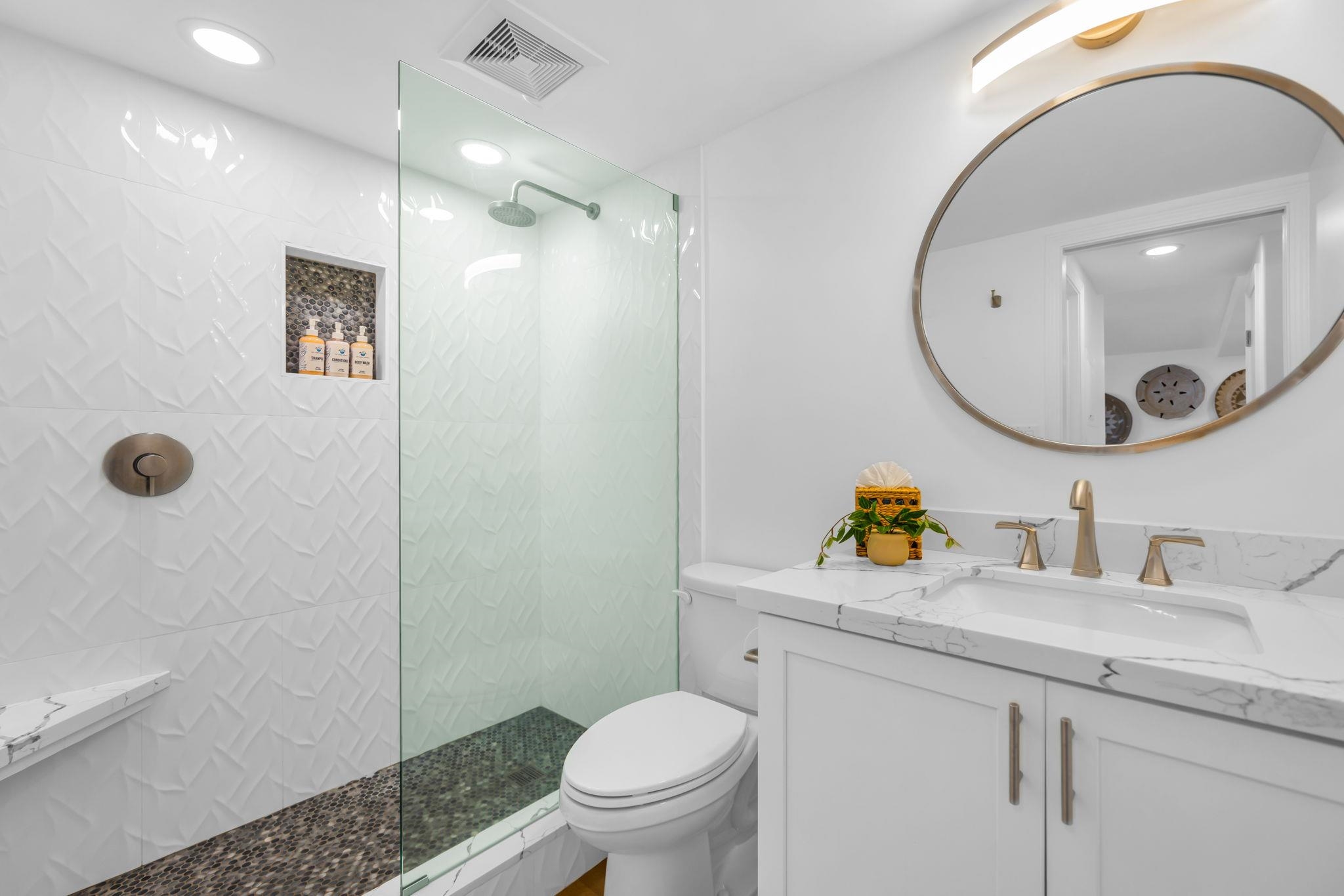 4401 Lower Honoapiilani Road, Unit B603 Lahaina, HI 96761 - Photo 27 of 41 a bathroom with a granite countertop toilet sink and mirror