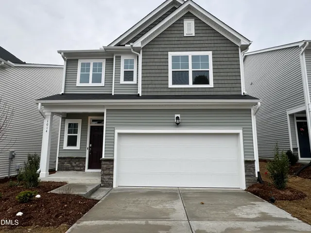 a front view of a house with a garage