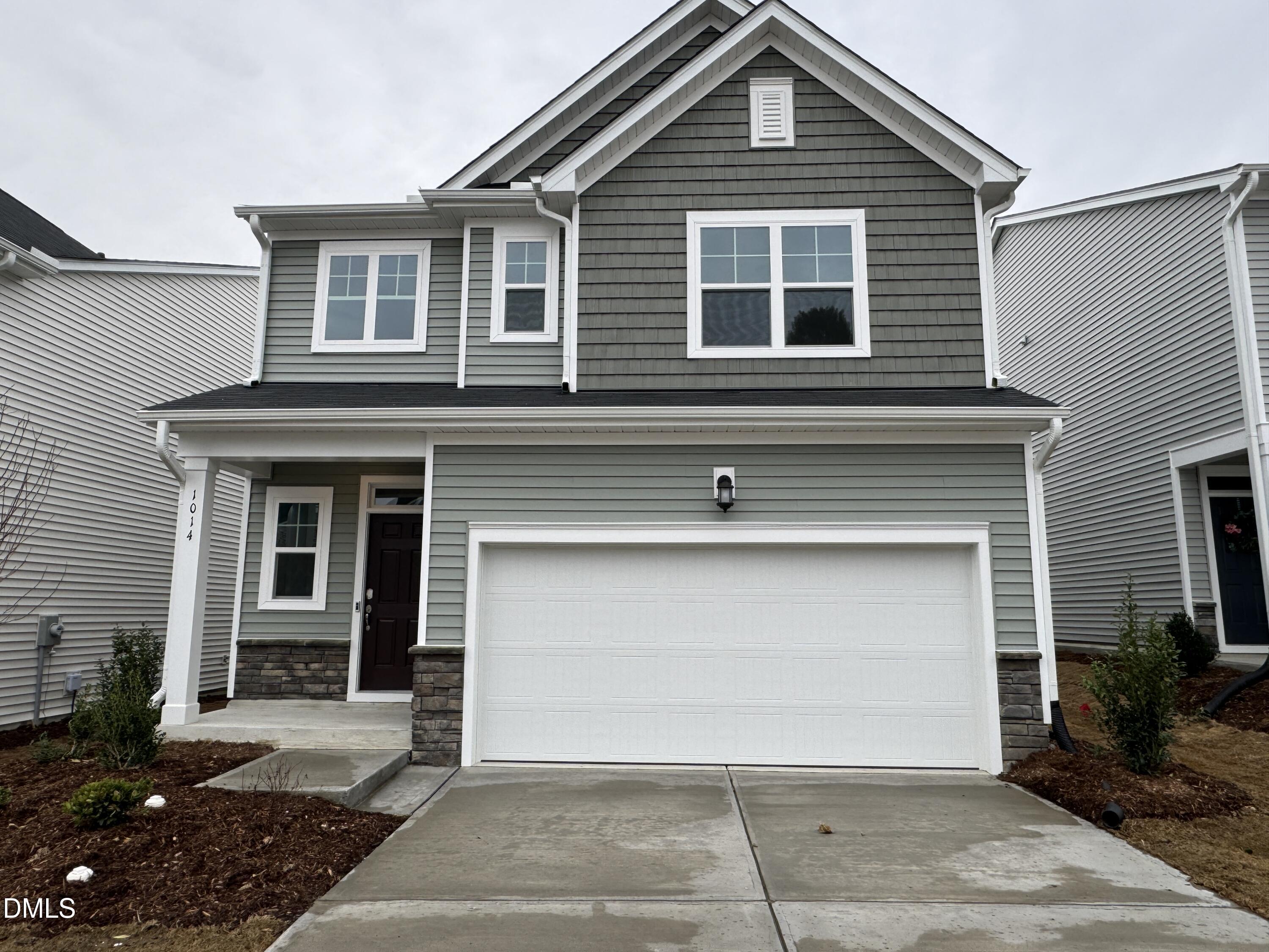 a front view of a house with a garage