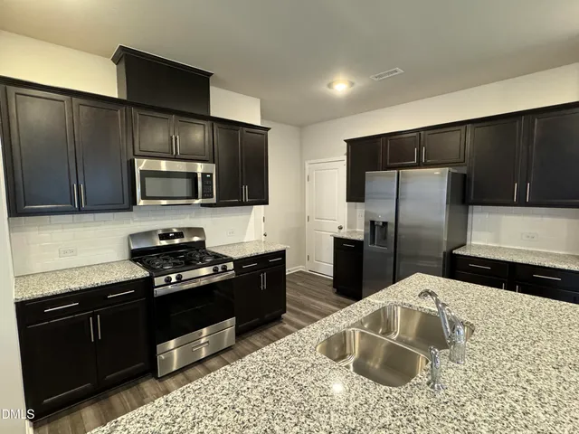 a kitchen with a refrigerator stove and microwave