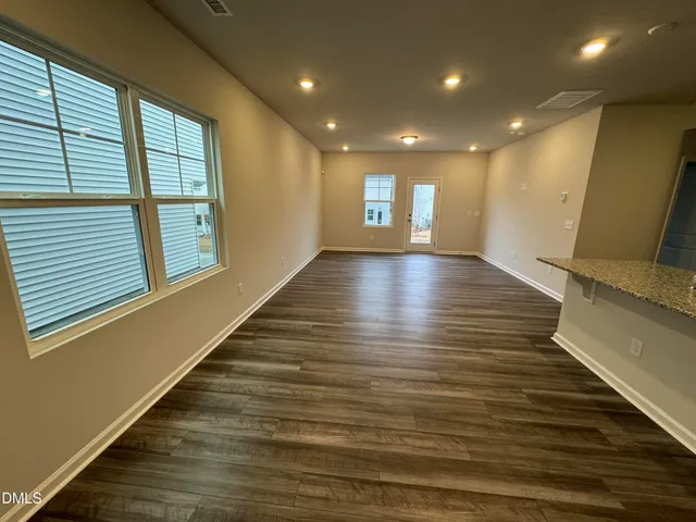 a view of a room with wooden floor