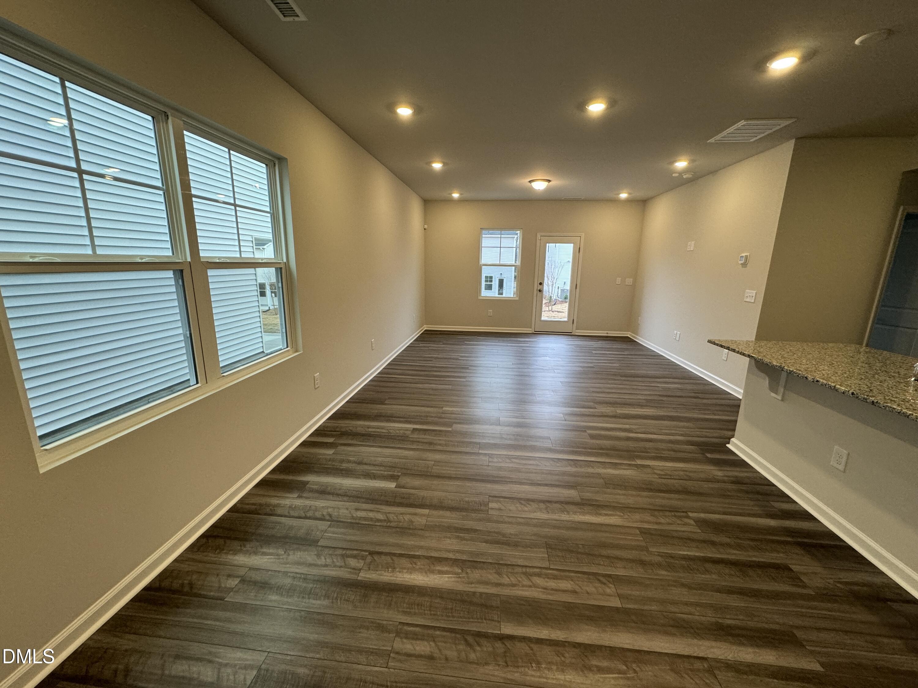 5706 Woodlawn Drive Durham, NC 27703 - Photo 4 of 20 a view of a room with wooden floor