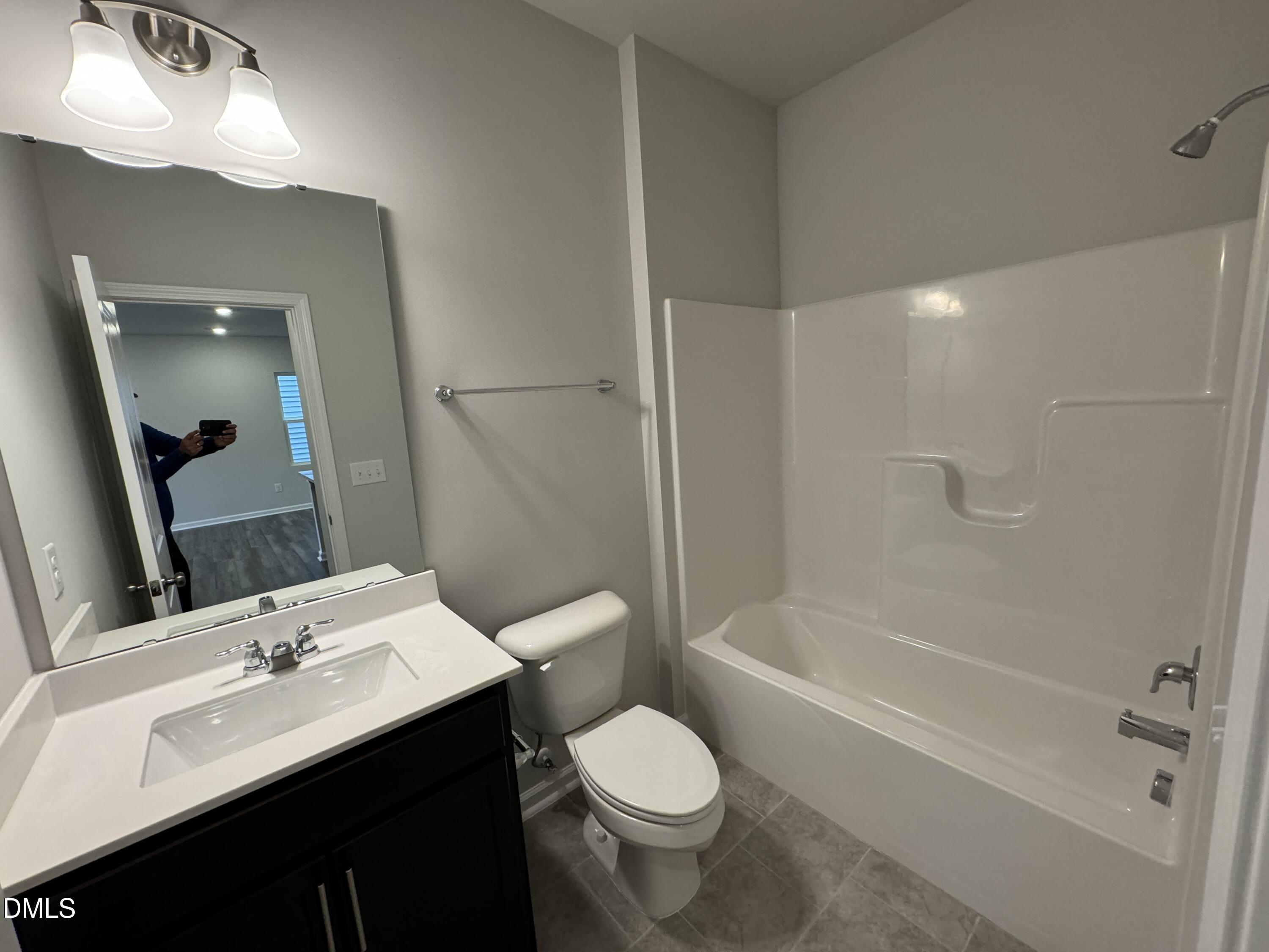 5706 Woodlawn Drive Durham, NC 27703 - Photo 7 of 20 a bathroom with a sink toilet and shower
