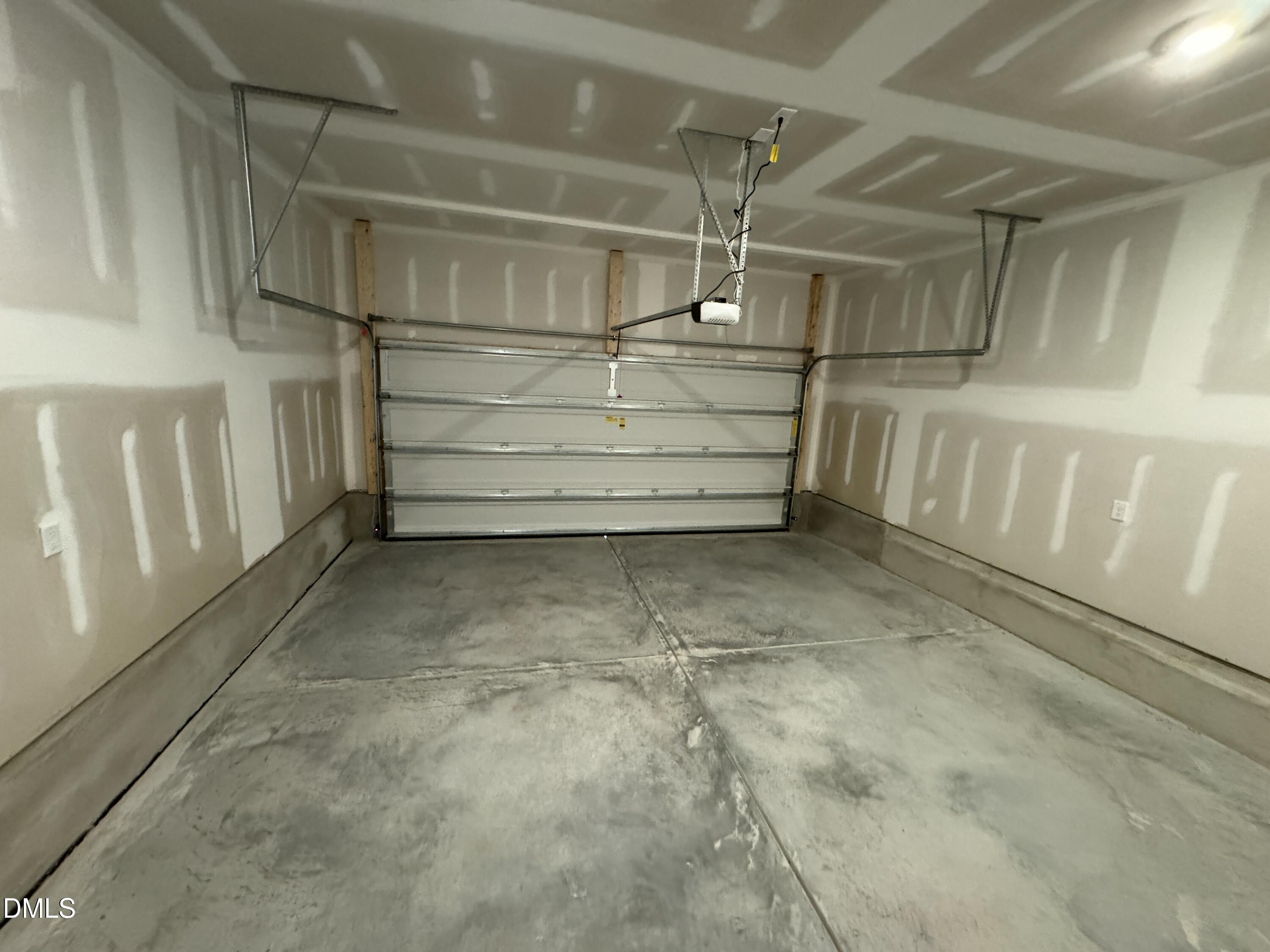 5706 Woodlawn Drive Durham, NC 27703 - Photo 9 of 20 a view of an empty room with racks on the wall