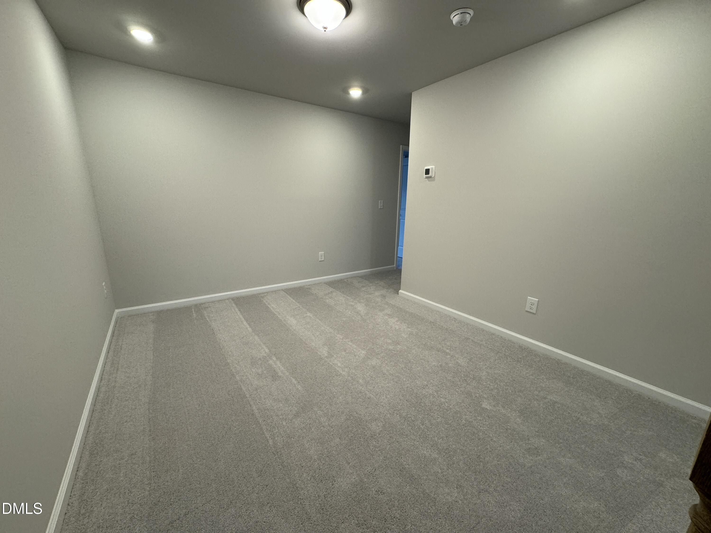 5706 Woodlawn Drive Durham, NC 27703 - Photo 10 of 20 an empty room with a natural light