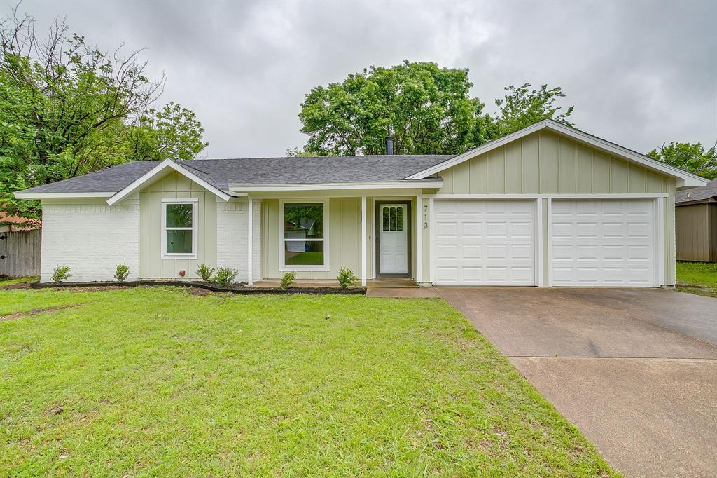 a view of a house with a yard and garage