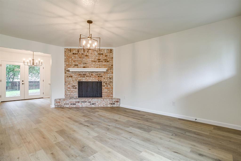713 Vaughn Drive Burleson, TX 76028 - Photo 13 of 40 an empty room with windows and fireplace