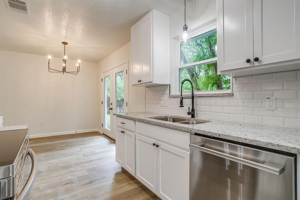 713 Vaughn Drive Burleson, TX 76028 - Photo 21 of 40 a kitchen with a sink and cabinets