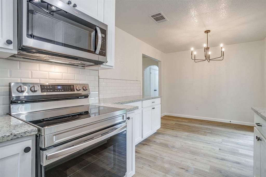 713 Vaughn Drive Burleson, TX 76028 - Photo 23 of 40 a kitchen with appliances and cabinets