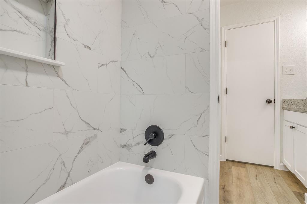 713 Vaughn Drive Burleson, TX 76028 - Photo 26 of 40 a bathroom with a white tub
