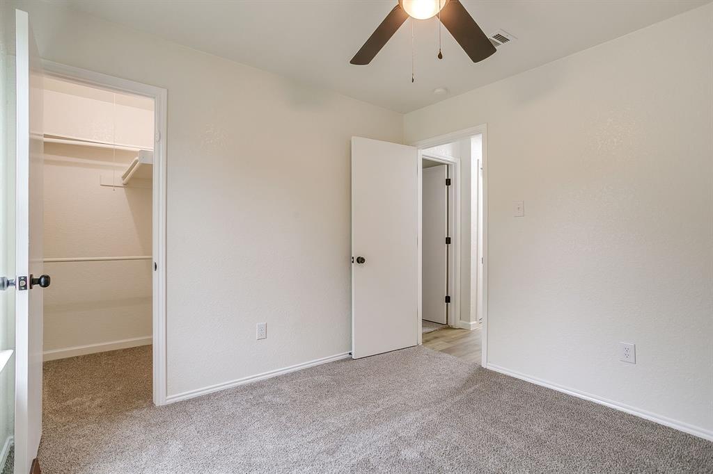713 Vaughn Drive Burleson, TX 76028 - Photo 28 of 40 an empty room with closet and a chandelier fan
