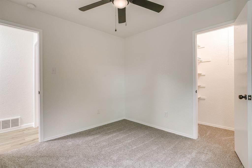 713 Vaughn Drive Burleson, TX 76028 - Photo 30 of 40 an empty room with a ceiling fan and window