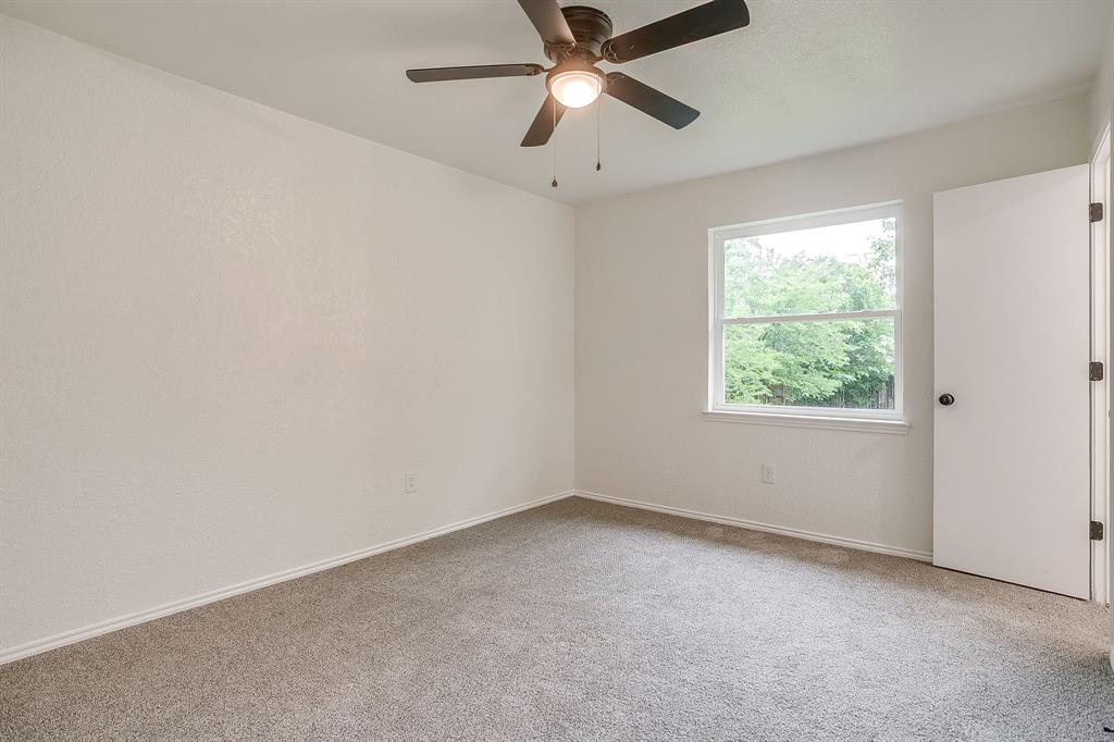 713 Vaughn Drive Burleson, TX 76028 - Photo 31 of 40 an empty room with a window and a fan