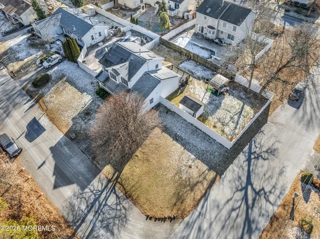 an aerial view of a residential apartment building with a yard