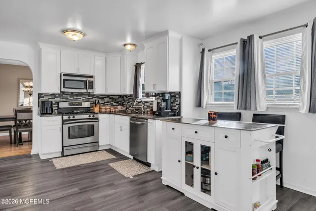 a kitchen with stainless steel appliances a stove a sink and a refrigerator