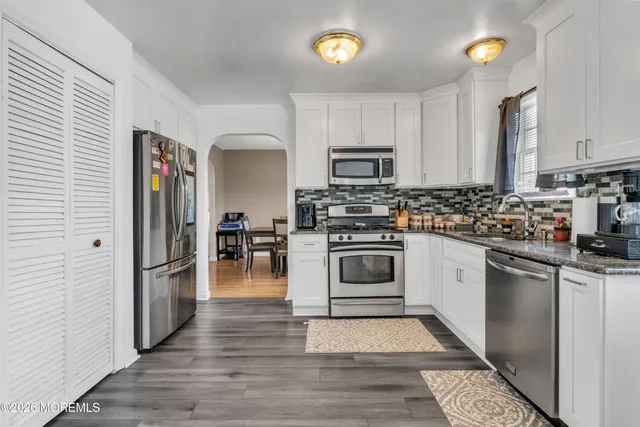 a kitchen with stainless steel appliances a stove cabinets and a refrigerator