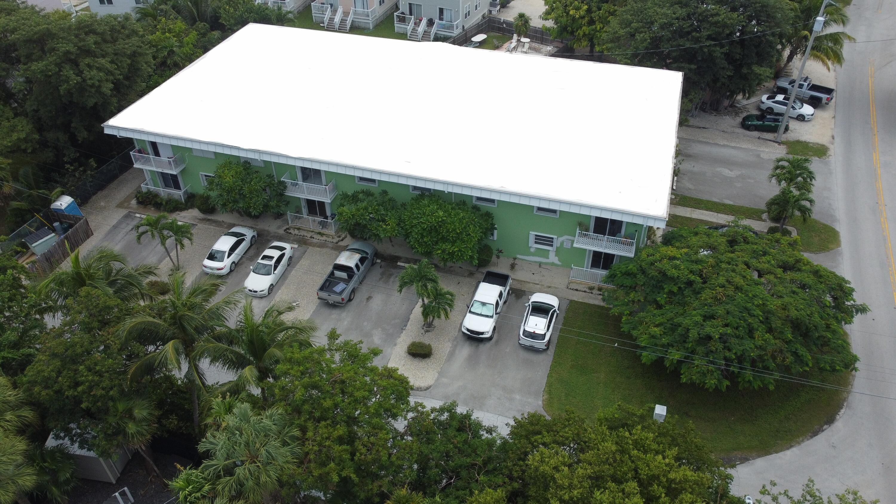 an aerial view of a house with garden space and street view
