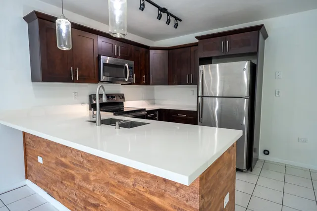 a kitchen with stainless steel appliances a refrigerator and a sink