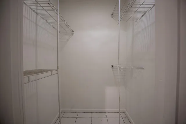 a view of kitchen with refrigerator cabinets and microwave