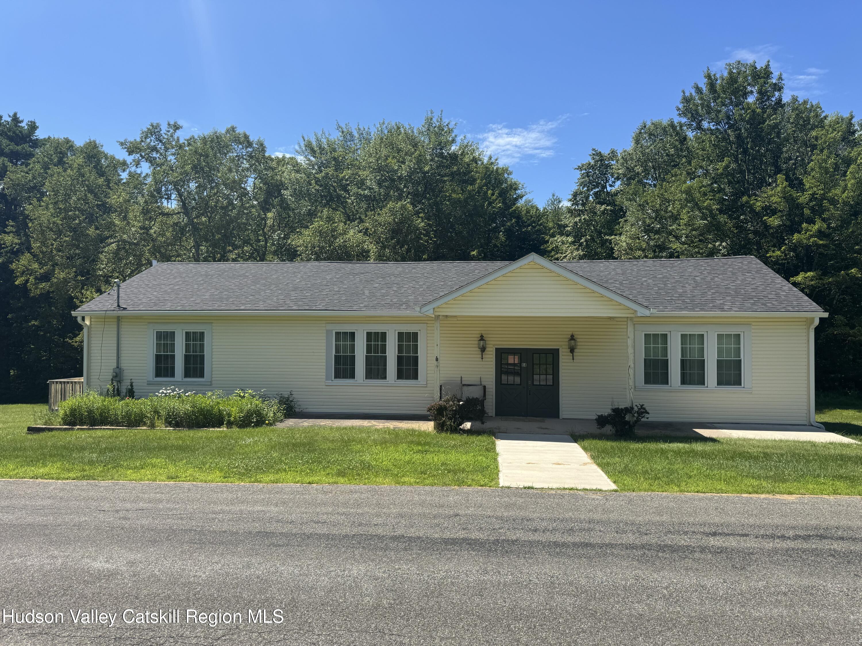 66-84 Katzman Road Ellenville, NY 12428 - Photo 1 of 30 a front view of a house with a garden