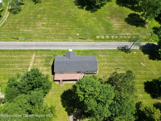 a view of a water pond with green field