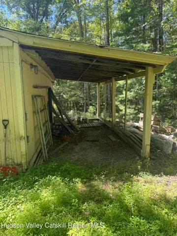 a backyard of a house with lots of green space and fountain