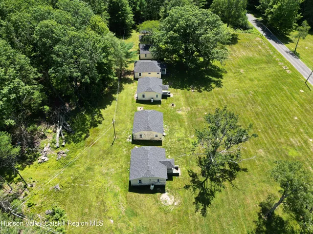 an aerial view of a house with a yard