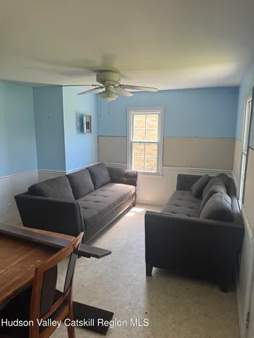 a living room with a couch and a window