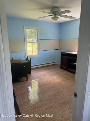 a view of a livingroom with a furniture window and wooden floor