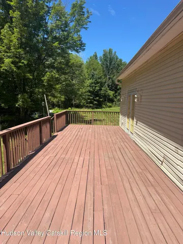 a view of backyard with a wooden deck
