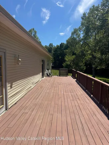 a view of a wooden deck with a yard