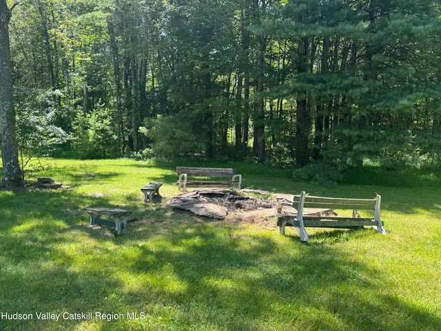 a view of a lake with a bench and trees