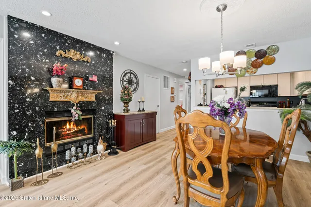 a view of a dining room with furniture and chandelier