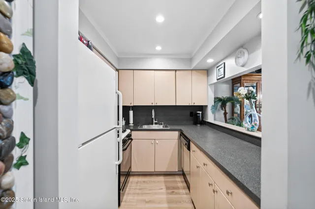 a kitchen with a sink and a refrigerator