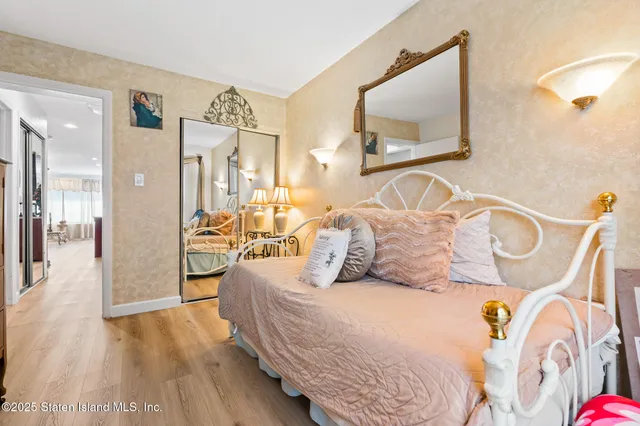 a bedroom with a bed and a mirror