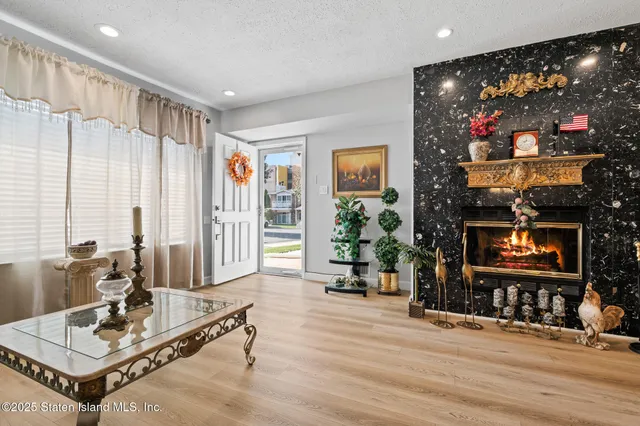 a living room with furniture a flat screen tv and a floor to ceiling window
