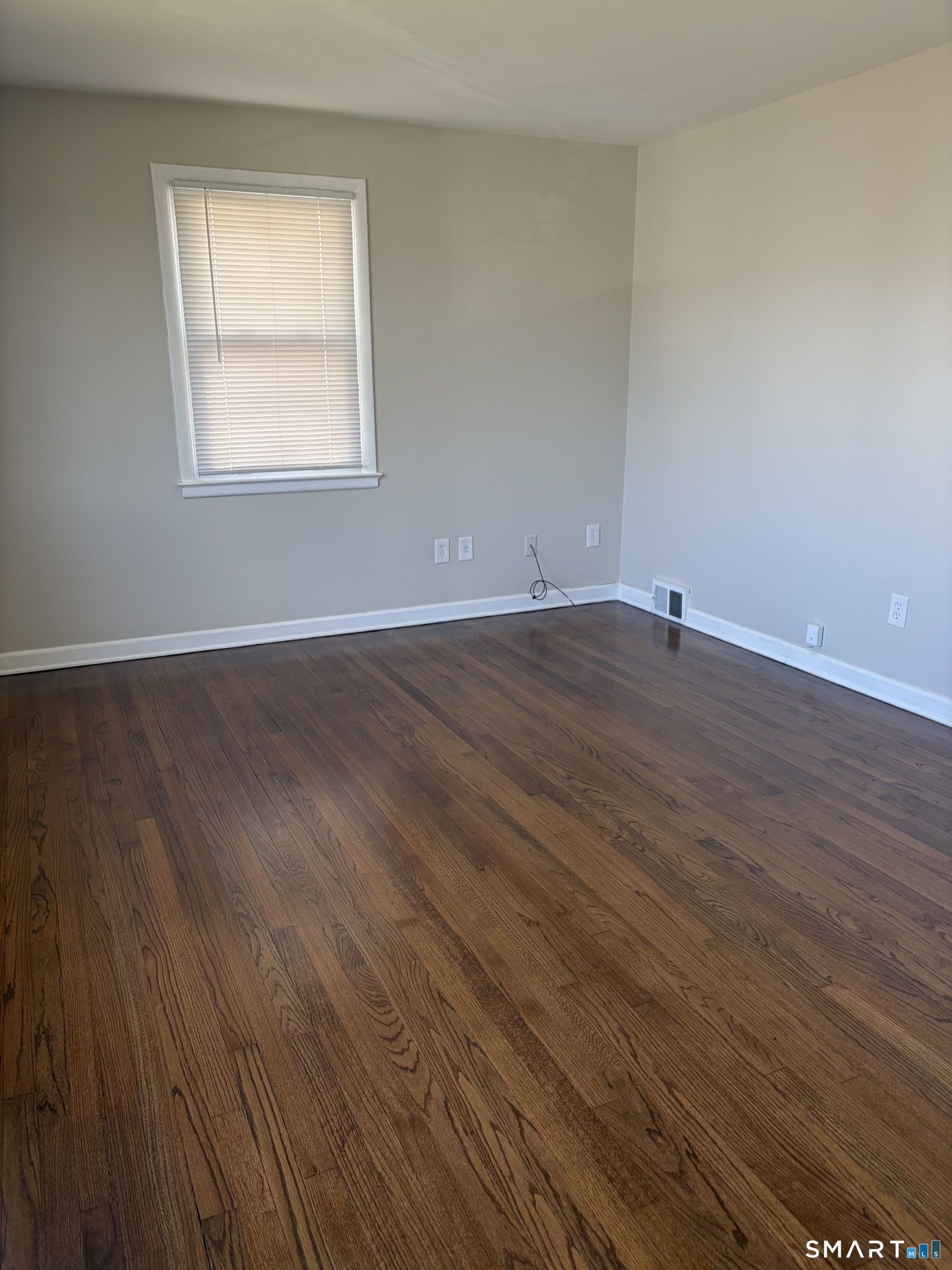 123 Longview Avenue Fairfield, CT 06824 - Photo 12 of 23 an empty room with wooden floor and windows