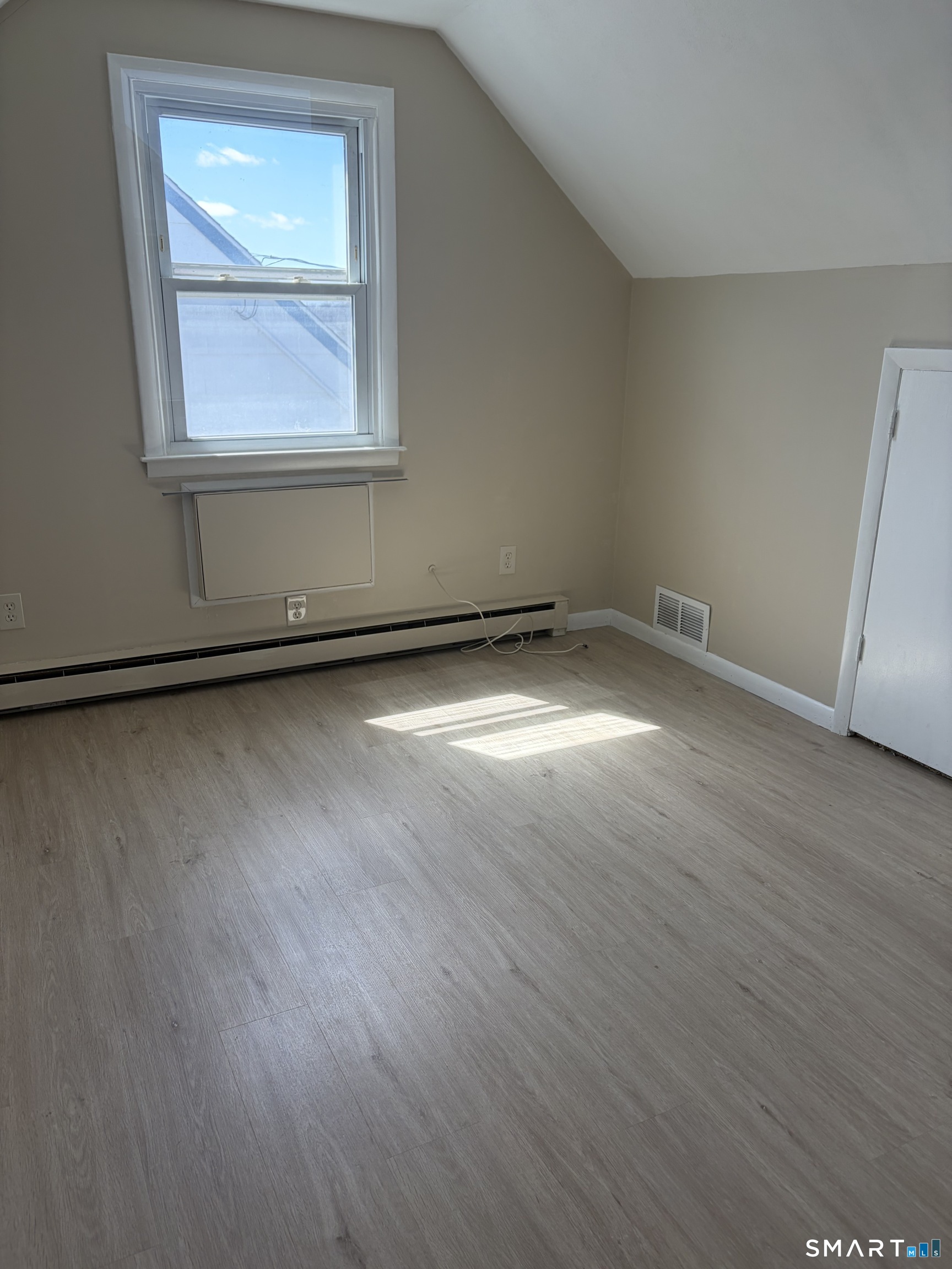 123 Longview Avenue Fairfield, CT 06824 - Photo 15 of 23 an empty room with wooden floor and windows