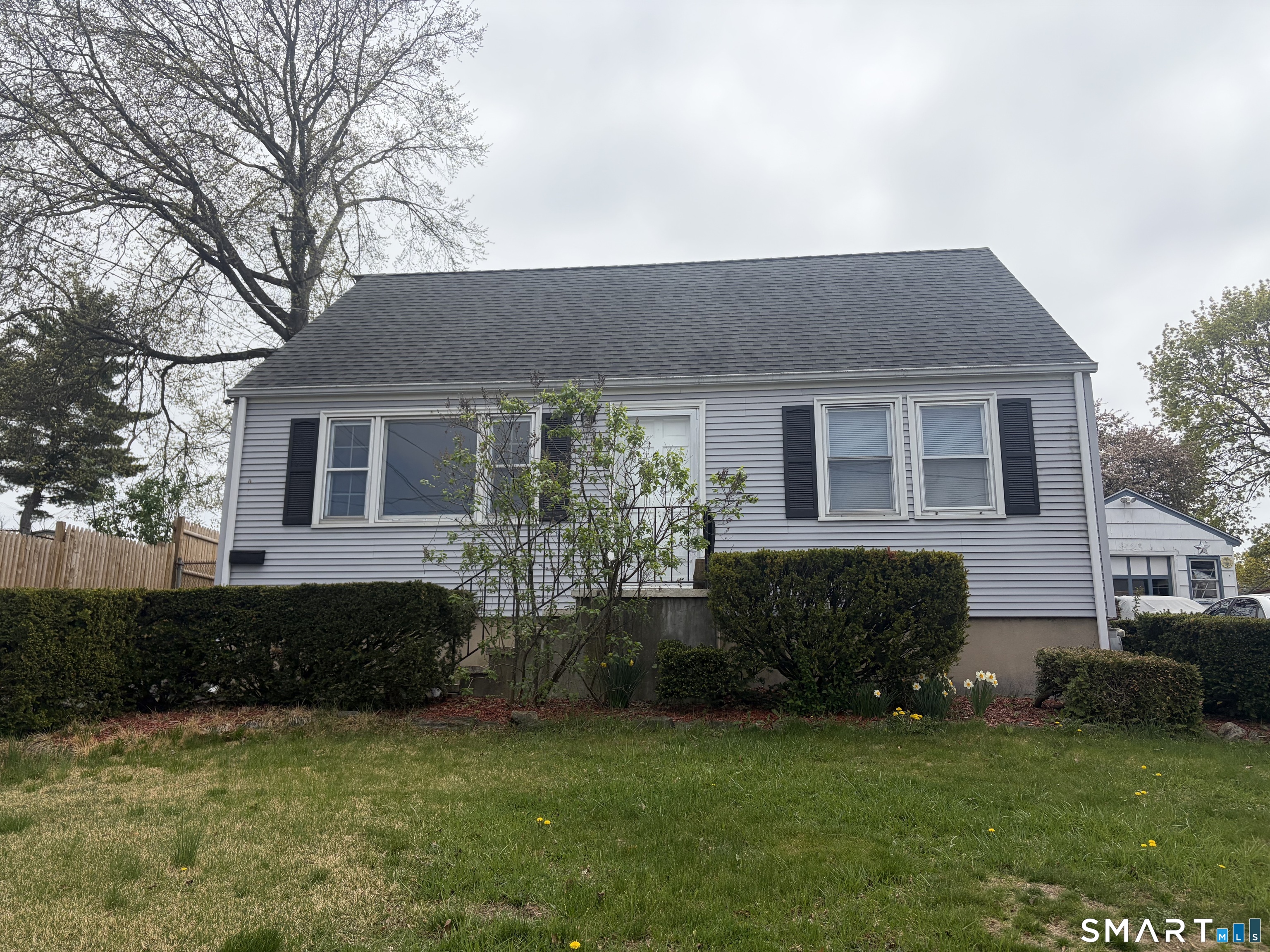 123 Longview Avenue Fairfield, CT 06824 - Photo 2 of 23 a front view of a house with a garden