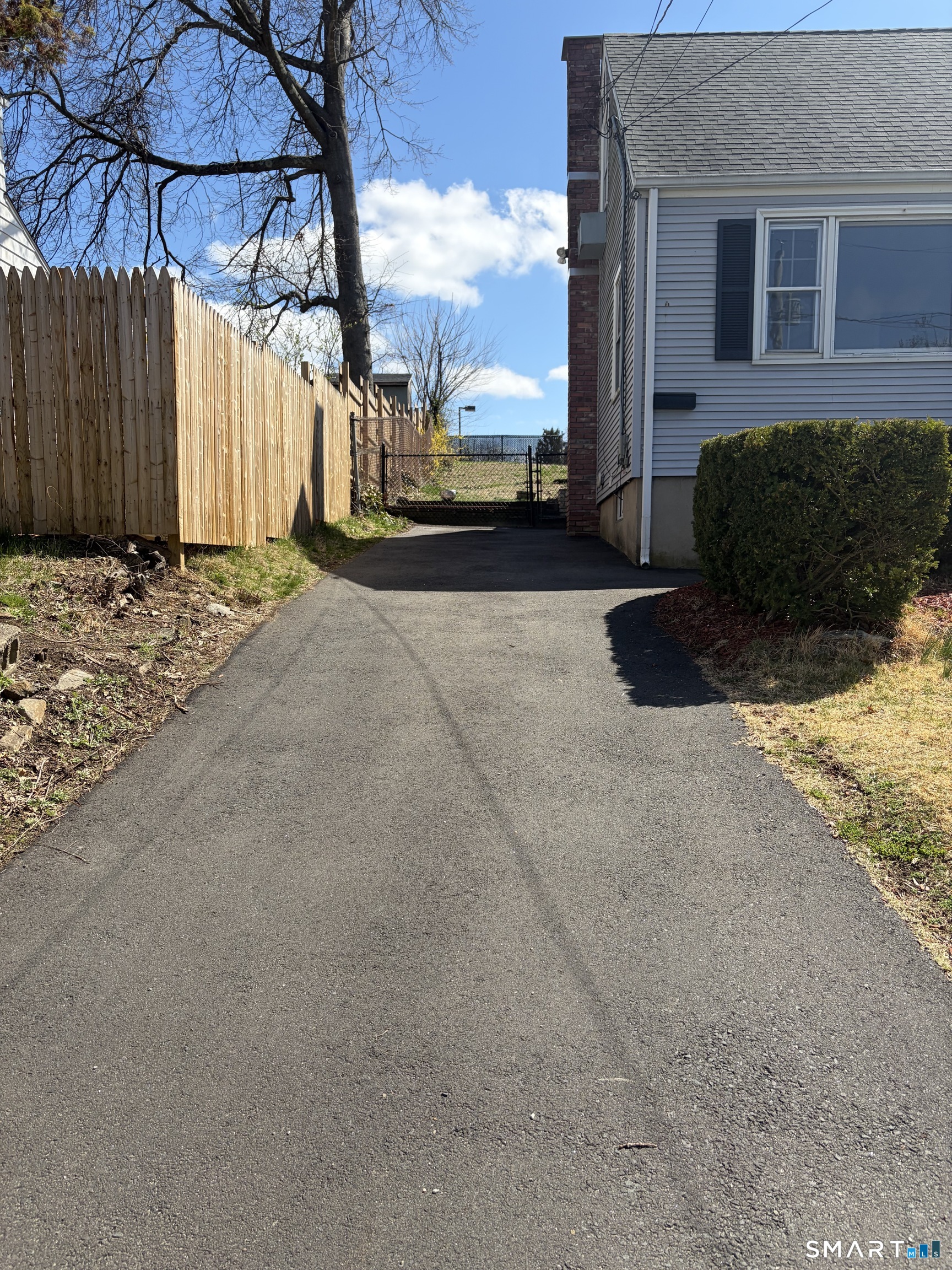 123 Longview Avenue Fairfield, CT 06824 - Photo 22 of 23 a view of a car park in front of a brick house