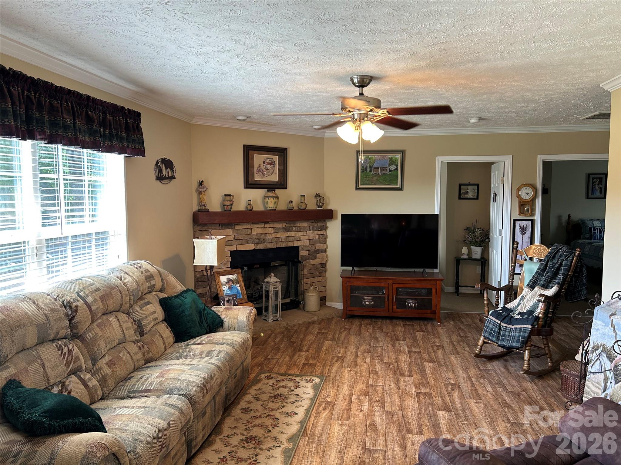 321 East Jones Street Blacksburg, SC 29702 - Photo 5 of 11 a living room with furniture a flat screen tv and a fireplace