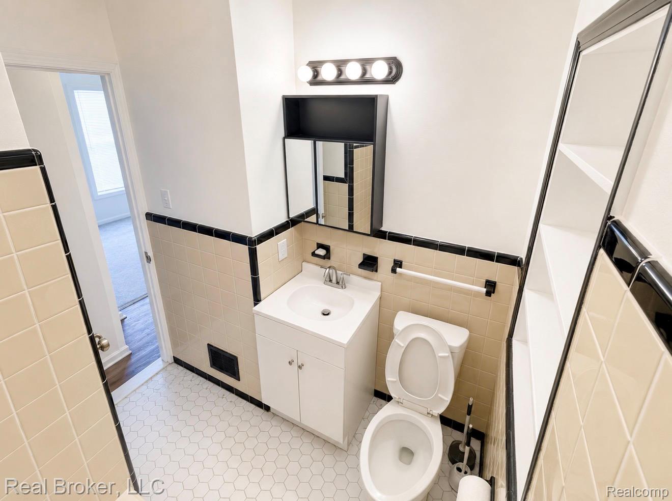 603 Vernier Road Grosse Pointe, MI 48236 - Photo 10 of 33 Bathroom with vanity, tile walls, and wainscoting