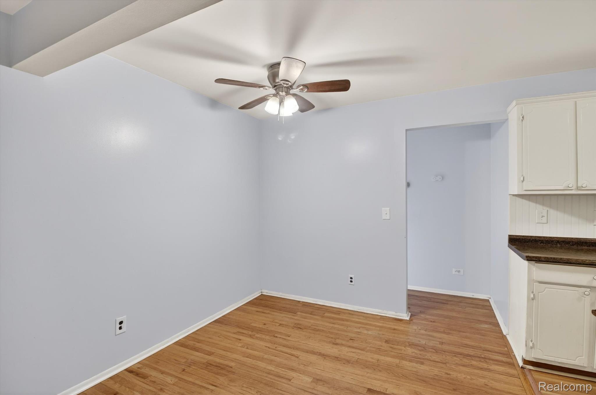 25301 Five Mile Road, Unit 109 Redford, MI 48239 - Photo 10 of 22 Unfurnished dining area with light wood-type flooring and a ceiling fan