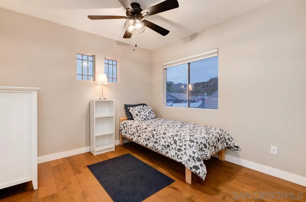 10205 Pinon Place Lakeside, CA 92040 - Photo 15 of 23 a bed sitting in a bedroom next to a window and a chandelier