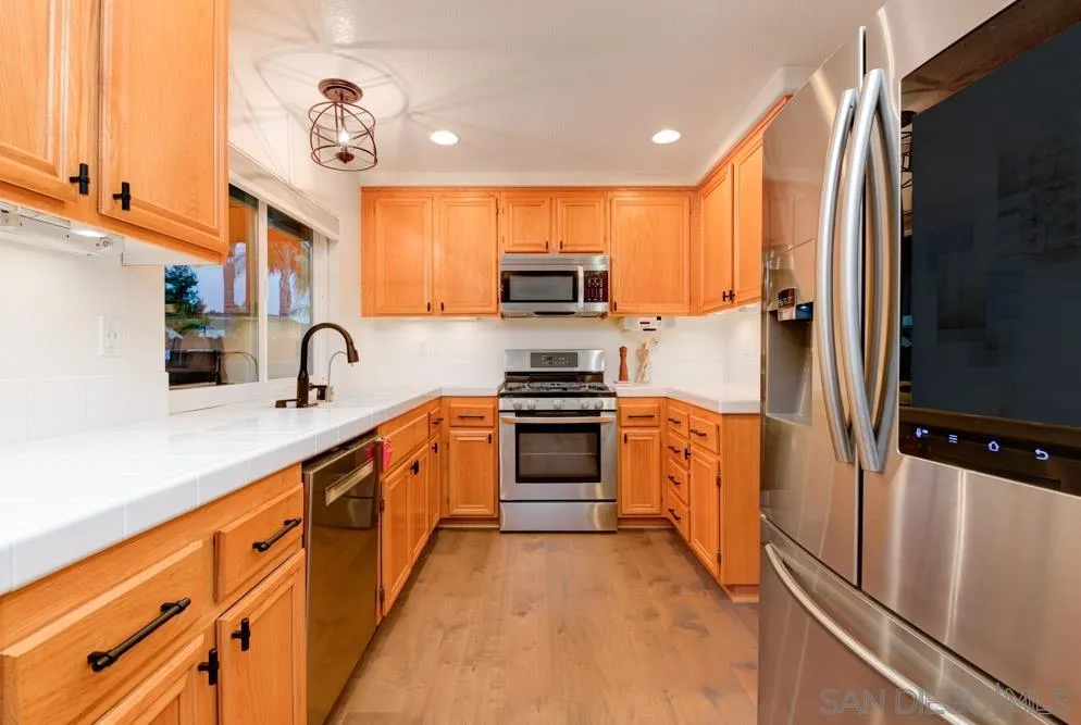 10205 Pinon Place Lakeside, CA 92040 - Photo 8 of 23 a kitchen with stainless steel appliances granite countertop a refrigerator and a sink