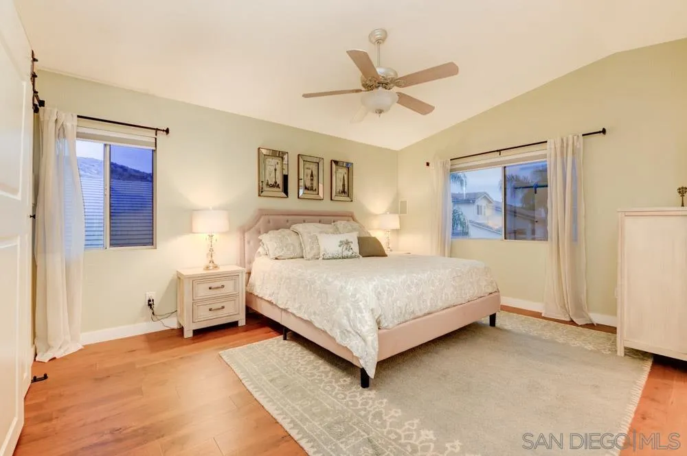 10205 Pinon Place Lakeside, CA 92040 - Photo 9 of 23 a bedroom with a bed and a chandelier