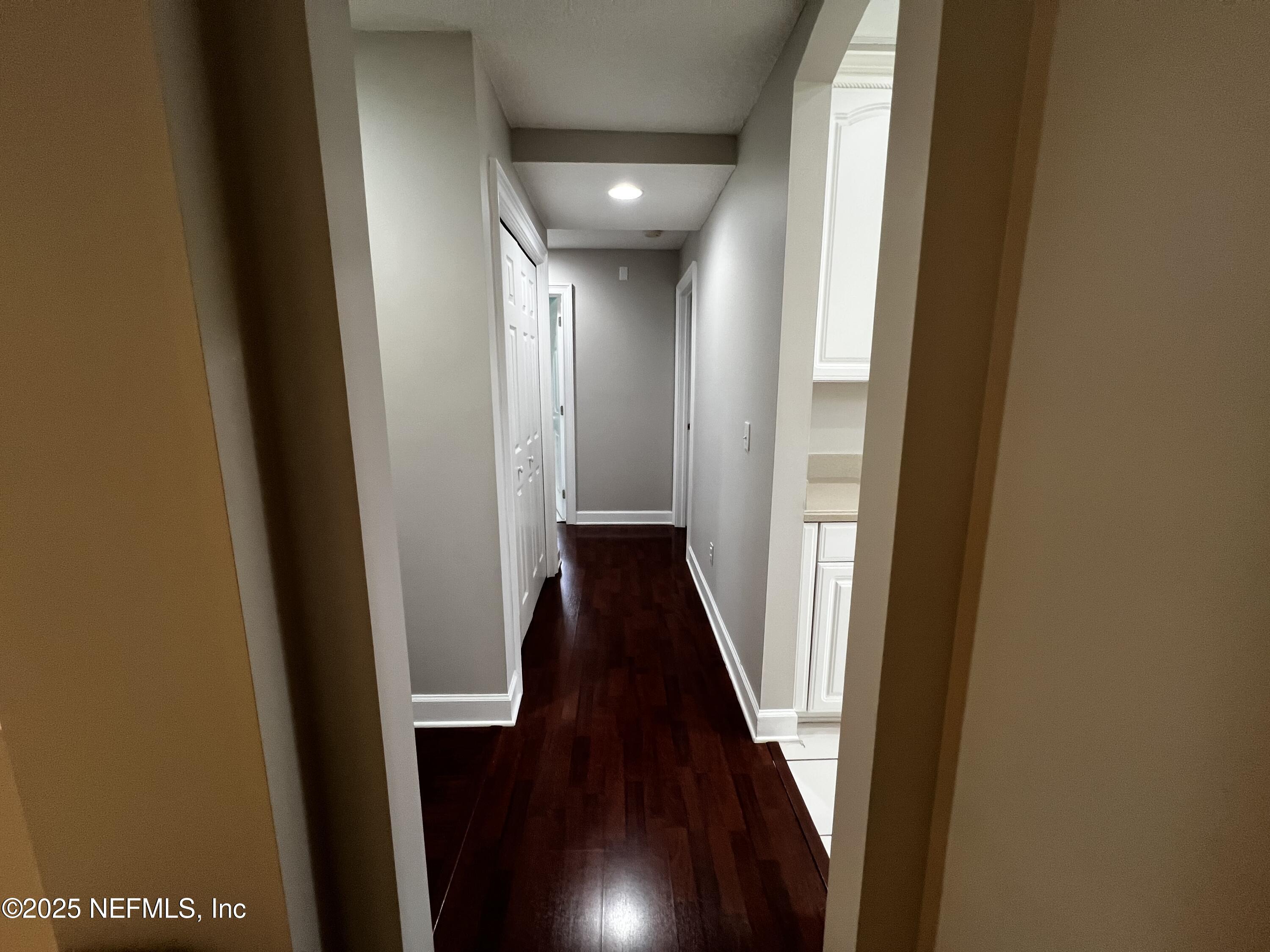 10310 Hamlet Glen Drive Jacksonville, FL 32221 - Photo 14 of 33 a view of a hallway with wooden floor