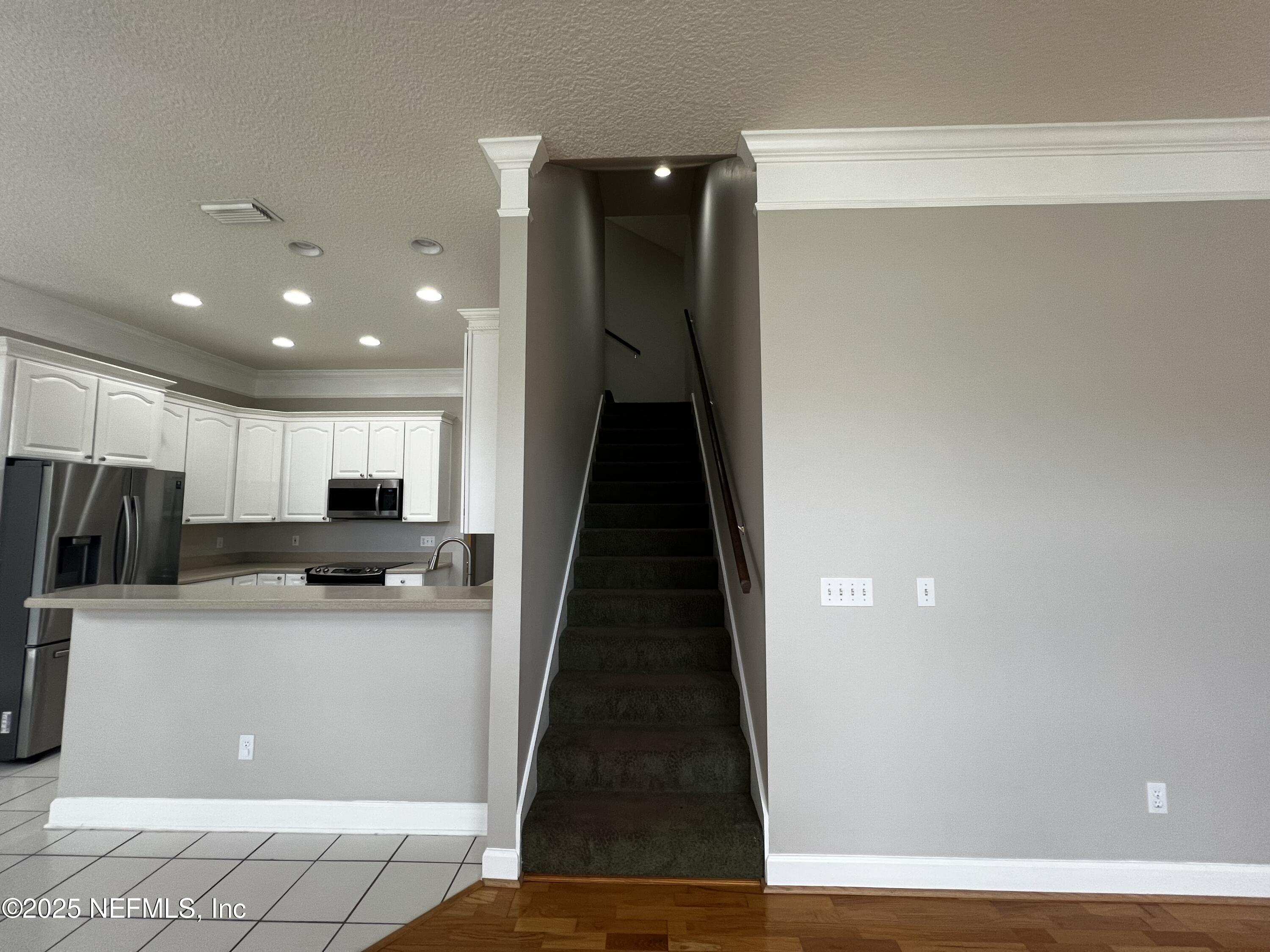 10310 Hamlet Glen Drive Jacksonville, FL 32221 - Photo 22 of 33 a kitchen with stainless steel appliances a refrigerator and a stove top oven