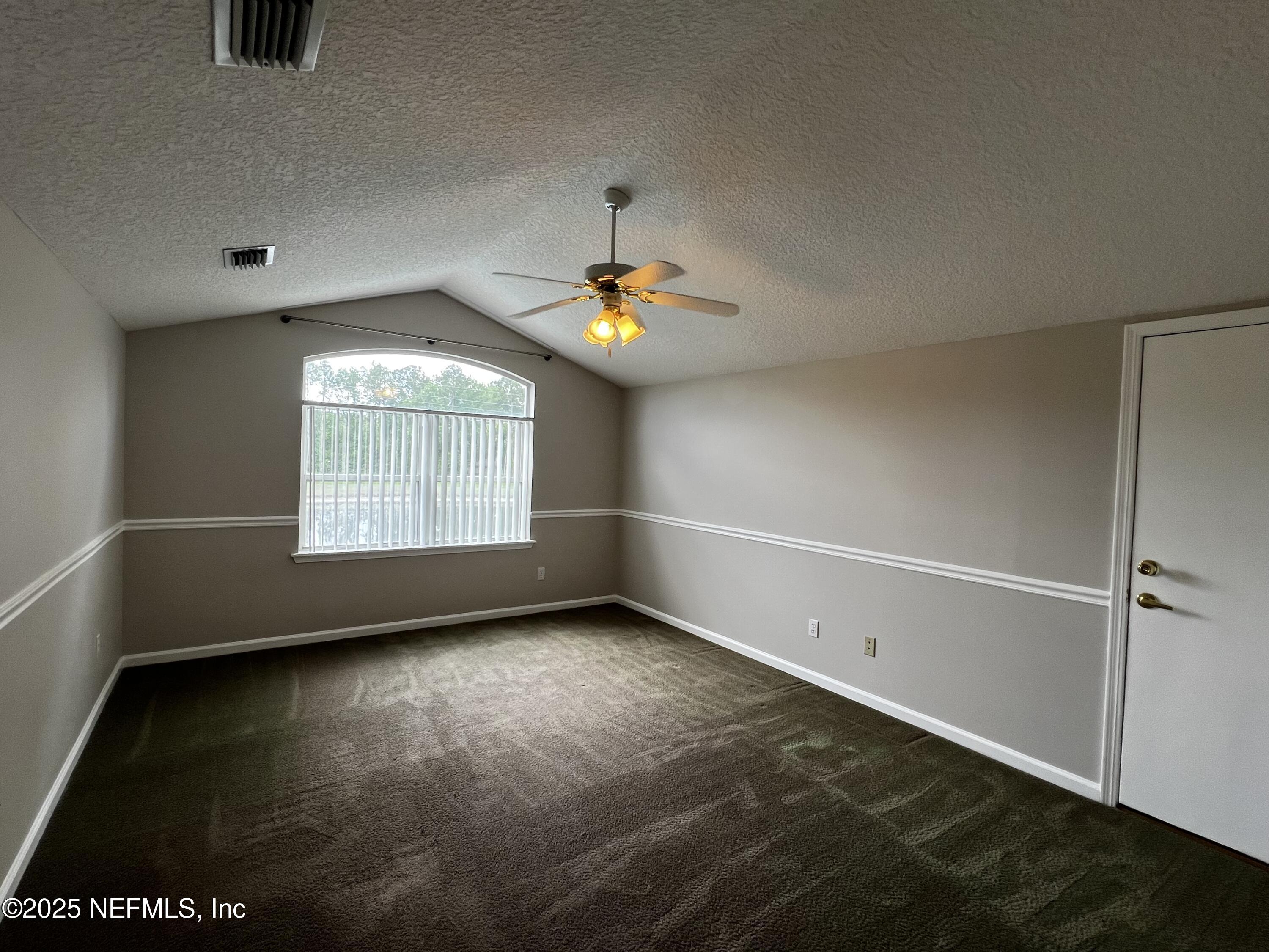 10310 Hamlet Glen Drive Jacksonville, FL 32221 - Photo 24 of 33 wooden floor in an empty room with a window